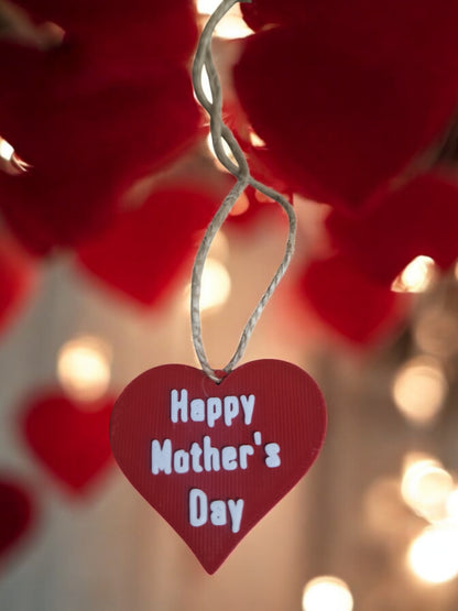 flower pot with red silk rose, two additional roses, two daffodils, love heart pendants reading 'I Love You' and 'Happy Mother’s Day', and a cute bee. Dimensions: 28cm (H) x 18cm (W) x 18cm (D). Perfect for Mother’s Day or Valentine’s Day, a lasting gift that doesn’t wilt.